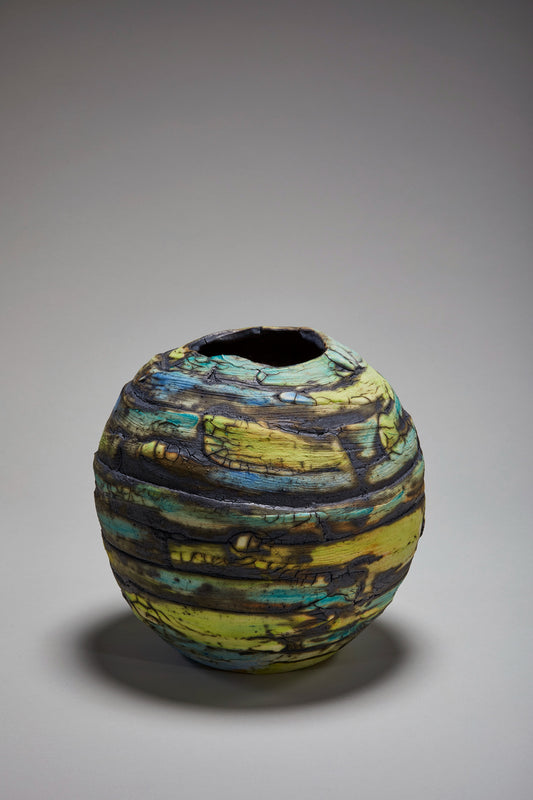 Marbled grey spherical vase with greens and blues. 