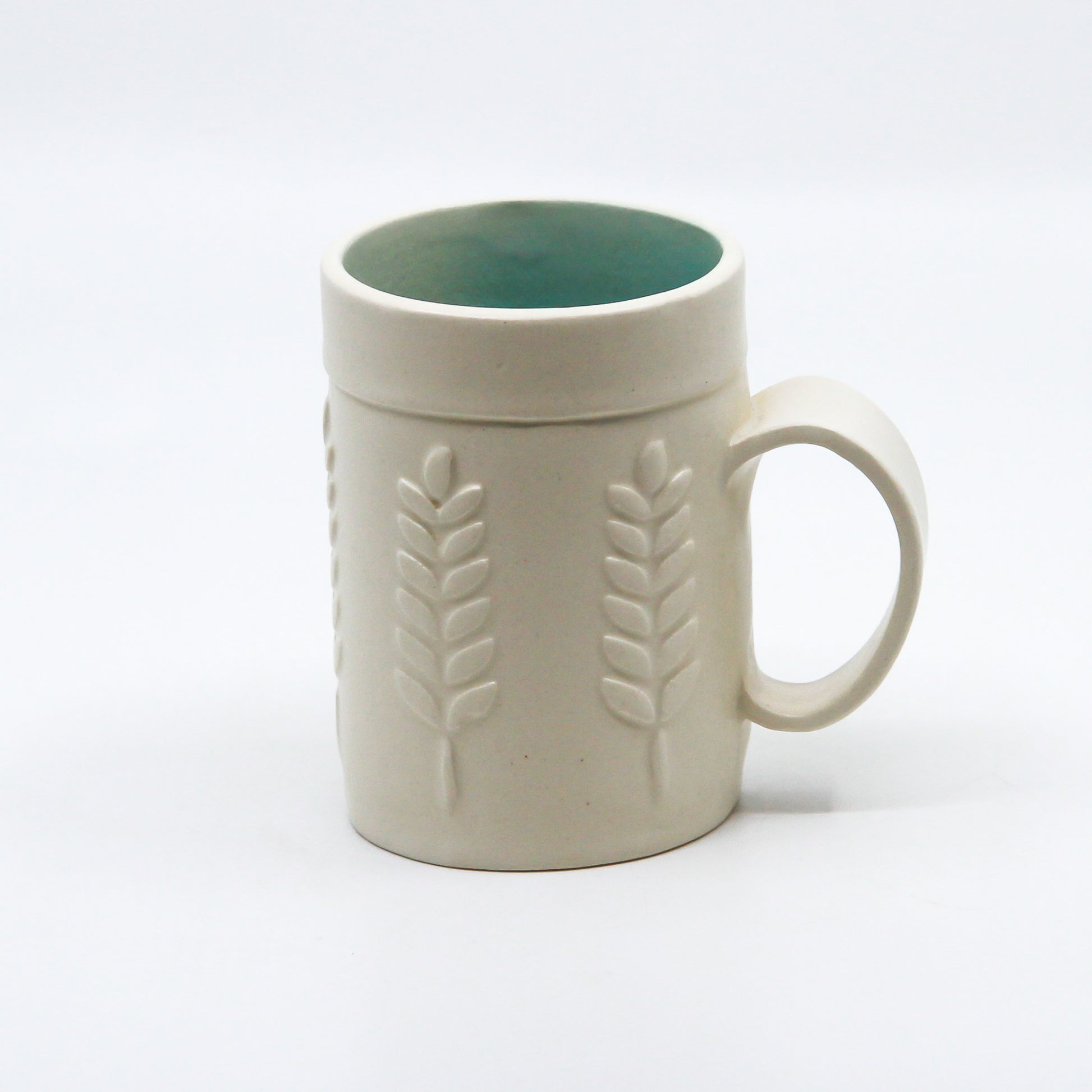 White mug with wheat and turquoise inside