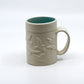White mug with birds and turquoise inside