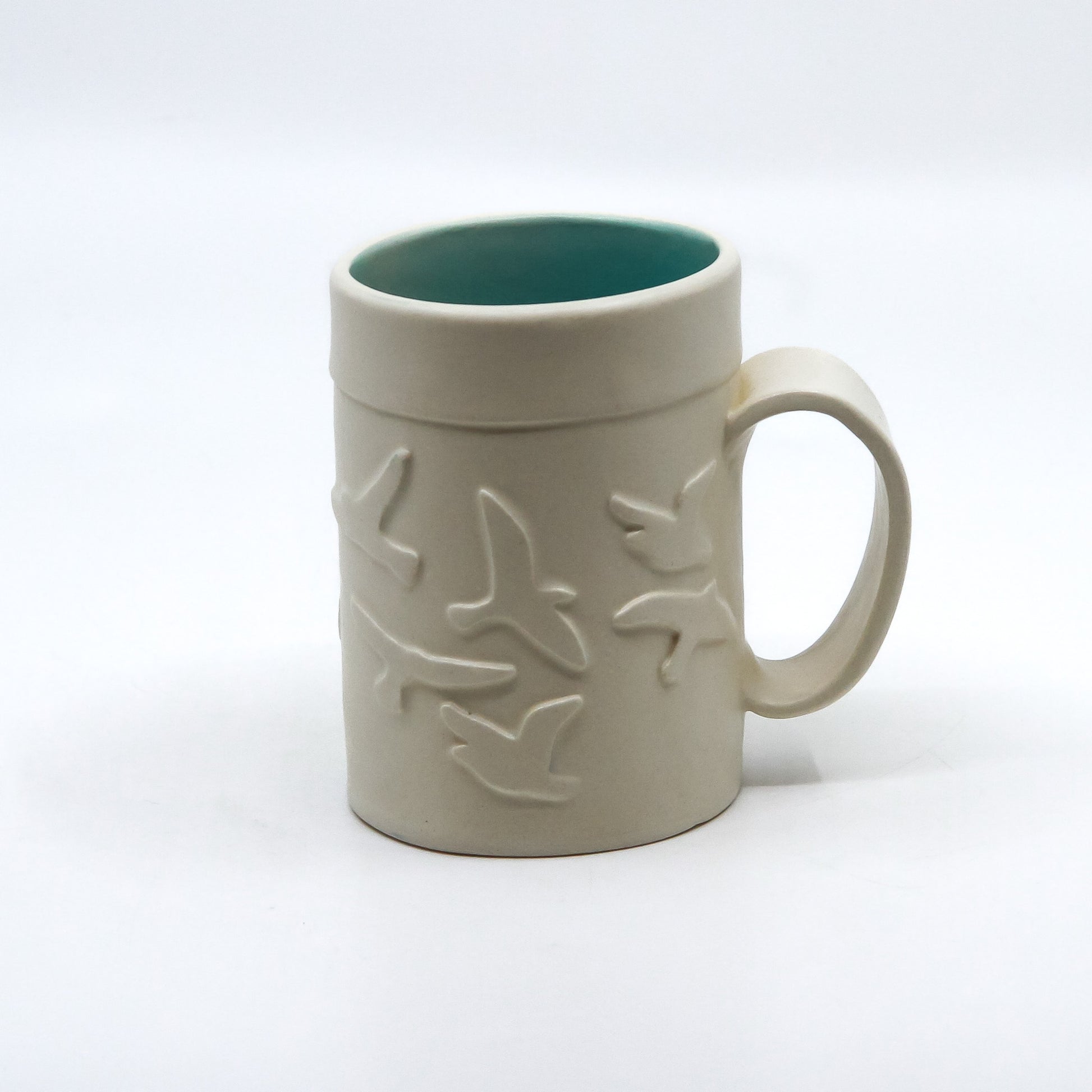 White mug with birds and turquoise inside