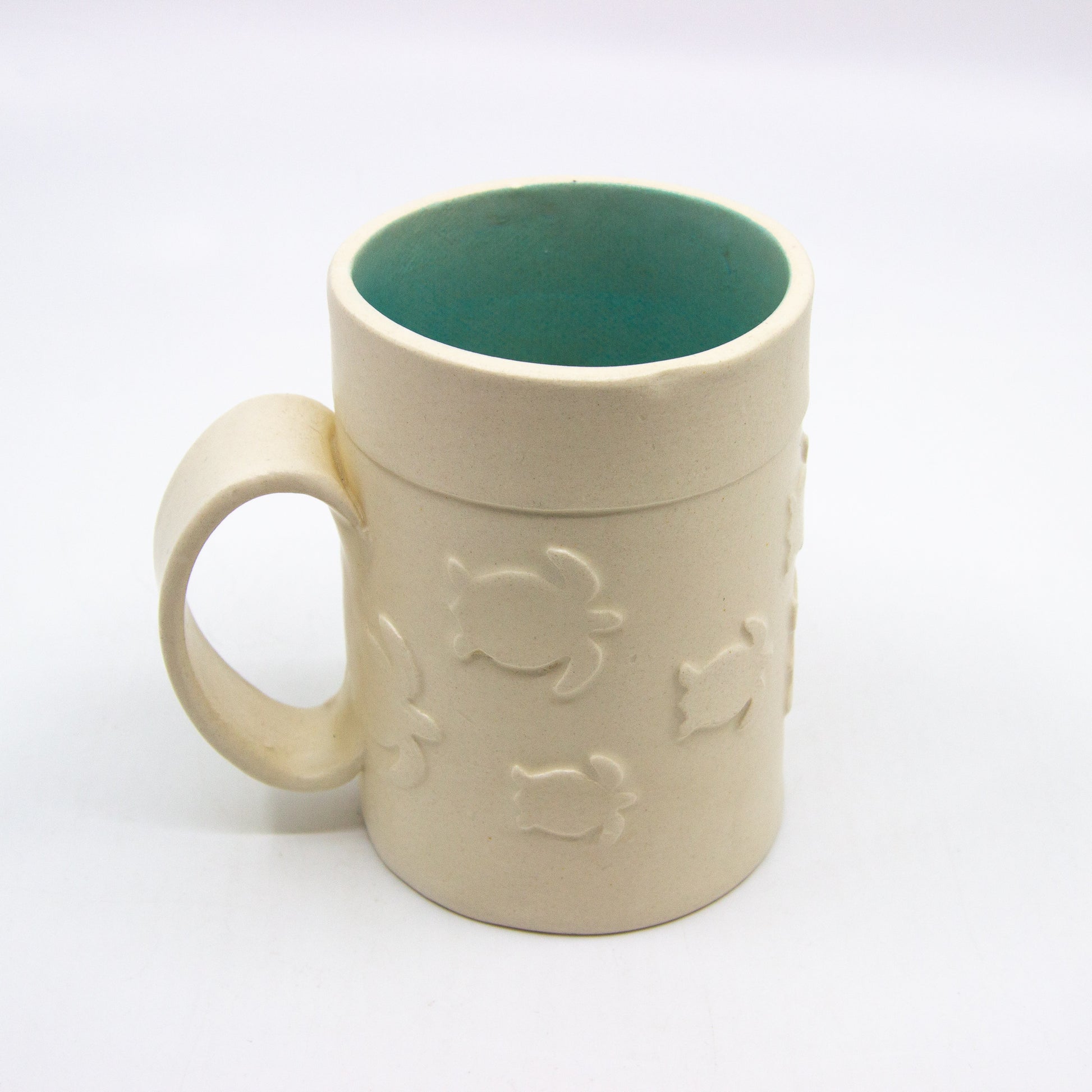 White mug with turtles and turquoise inside