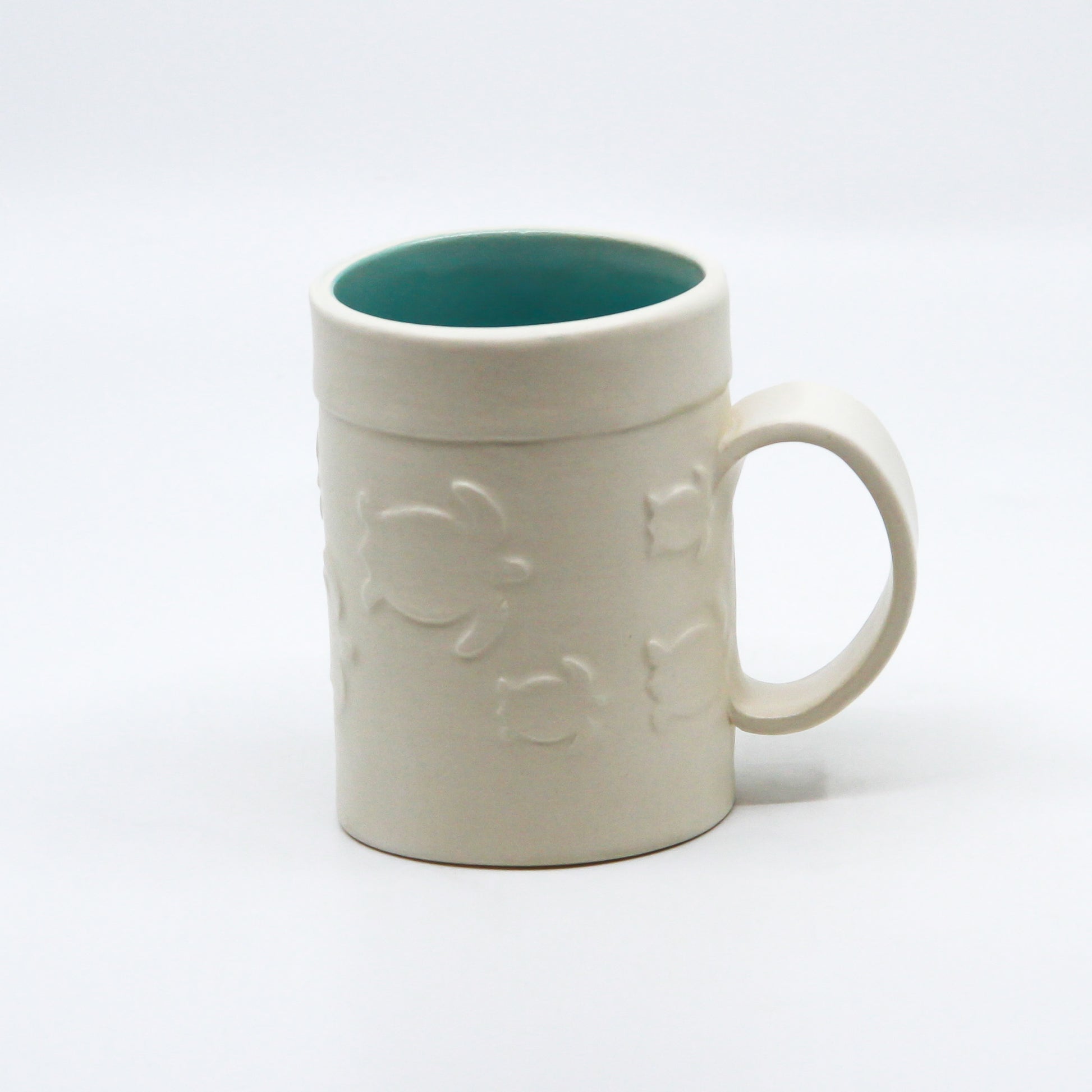 White mug with turtles and turquoise inside