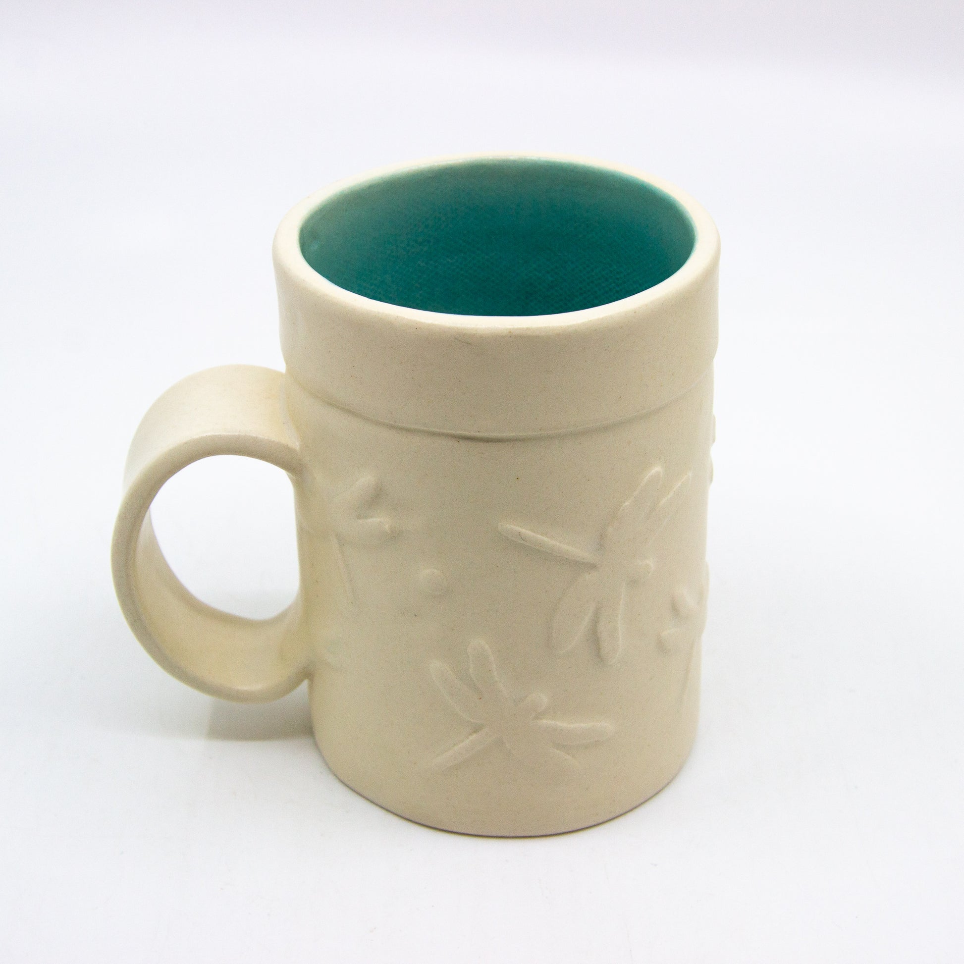 White mug with dragonflies and turquoise inside