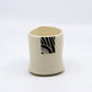 White tea cup with square pattern