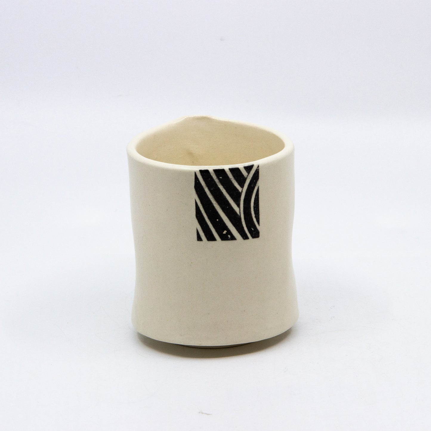 White tea cup with square black pattern
