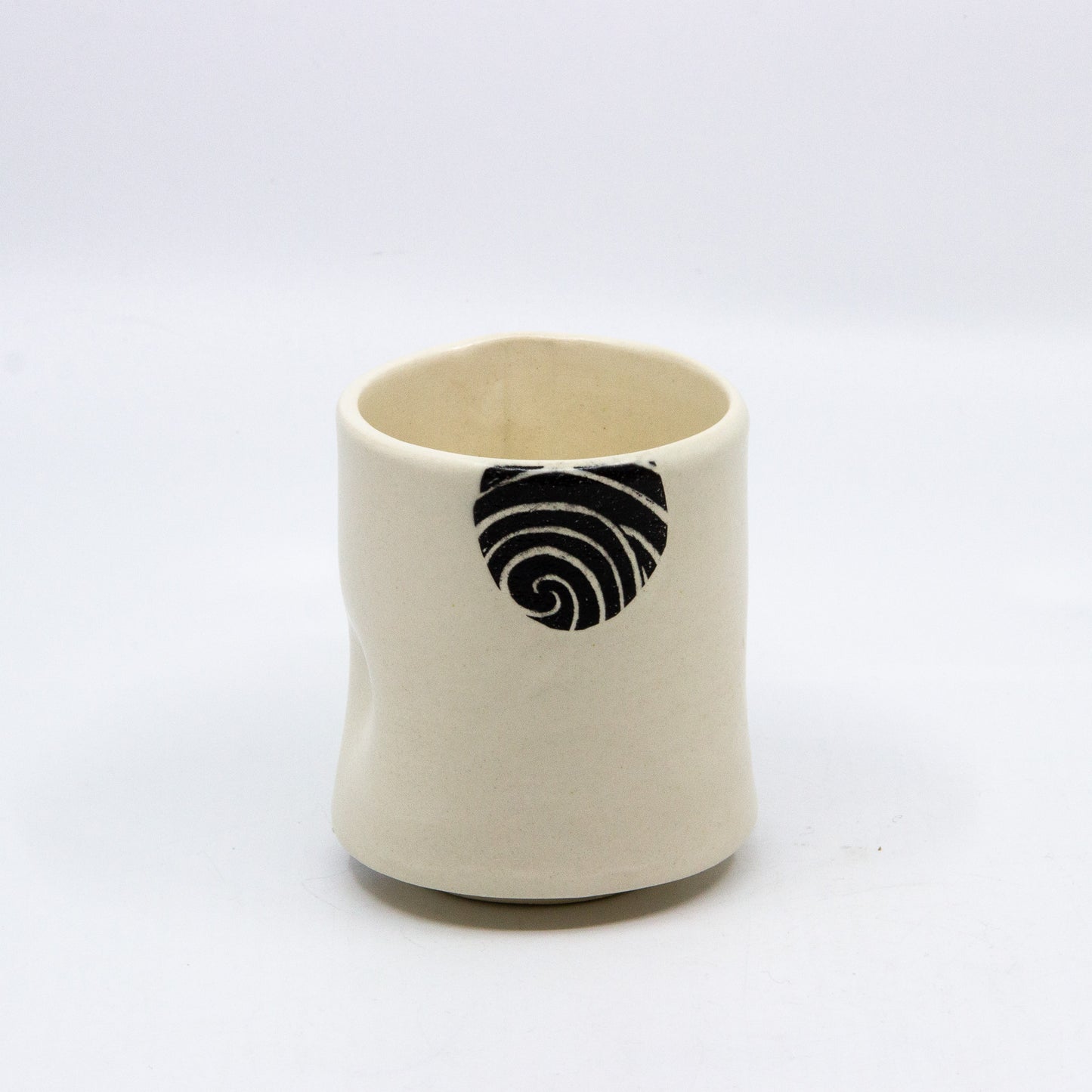 White tea cup with black circle pattern