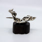 Silver modern miniature statue on wood stand