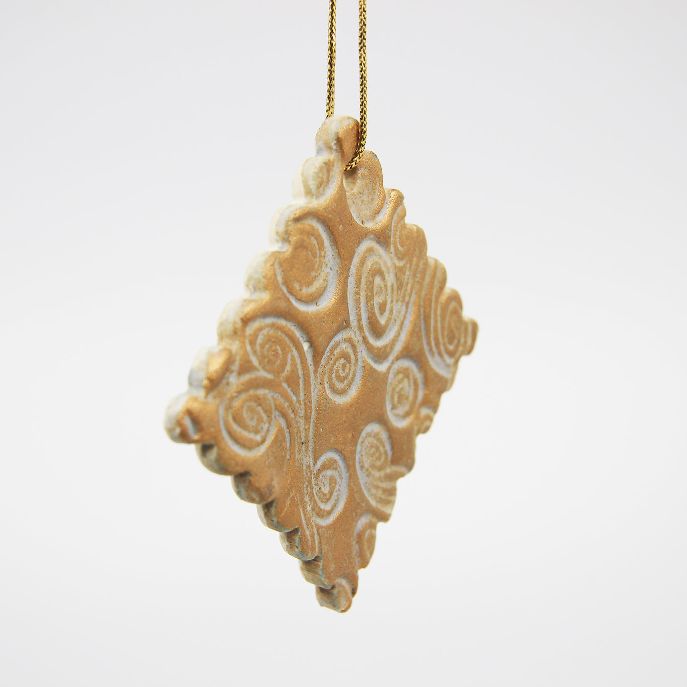 Golden diamond carved clay Christmas ornament with scalloped edges