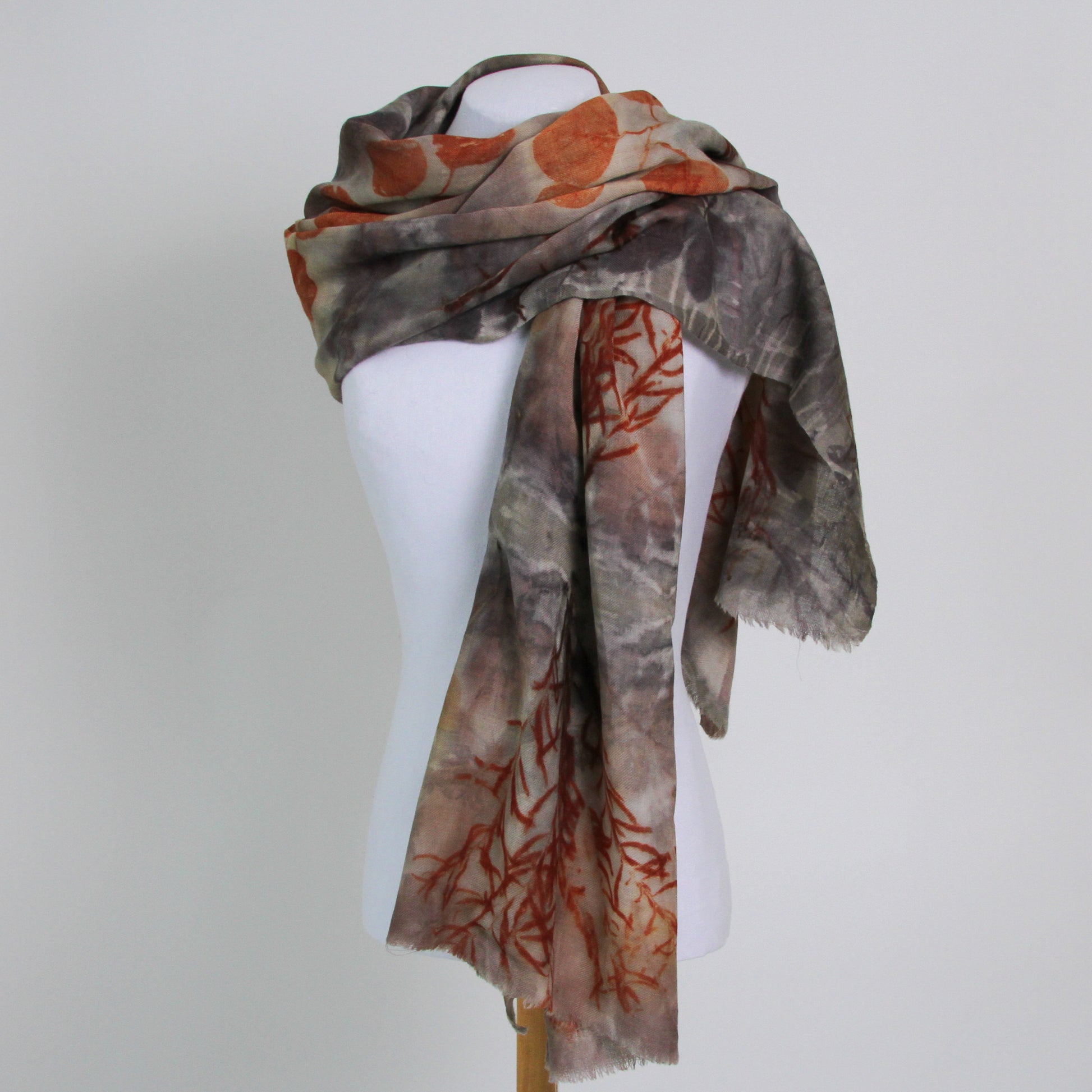 Brown wool scarf with orange printed leaves and foliage