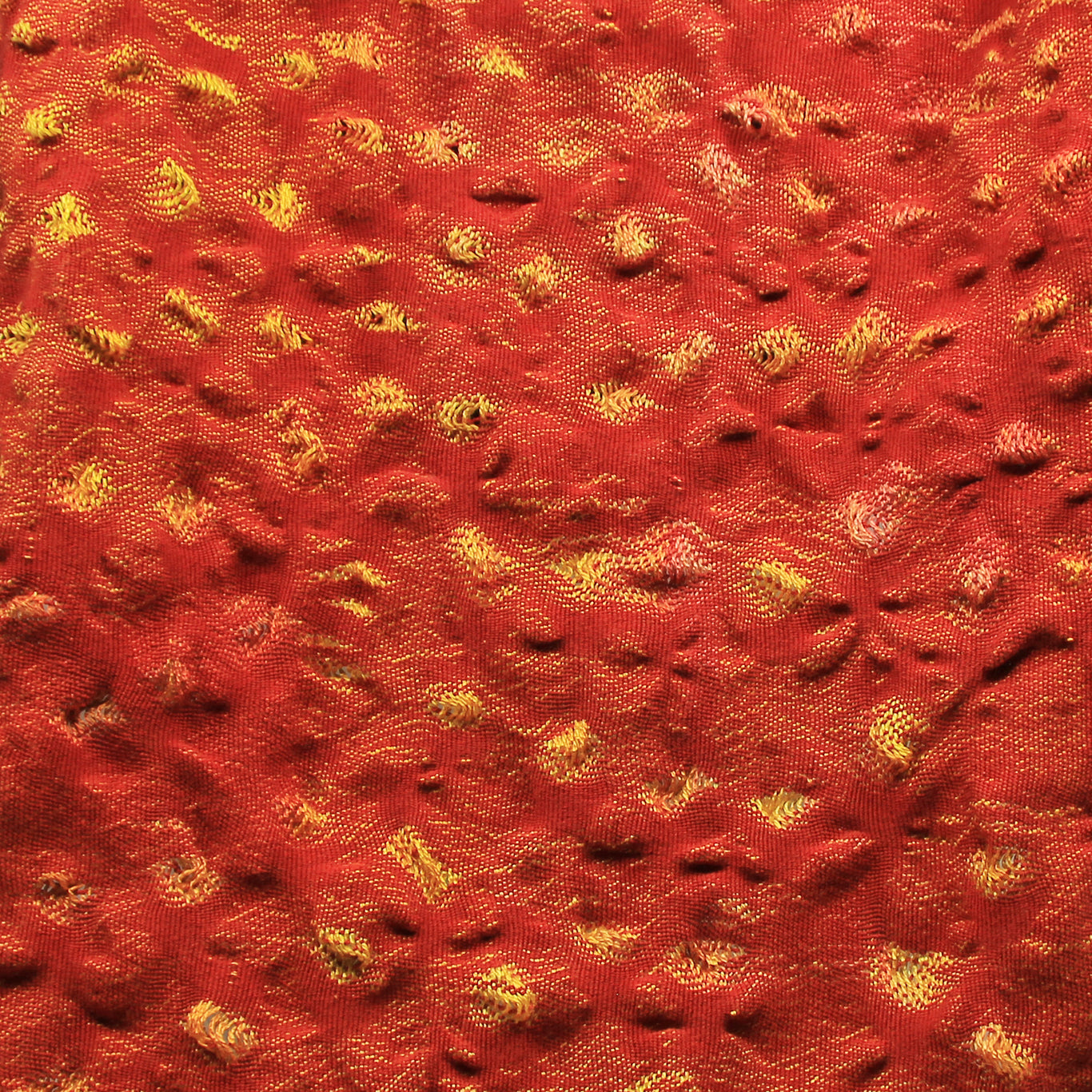Close up of red scarf with yellow 