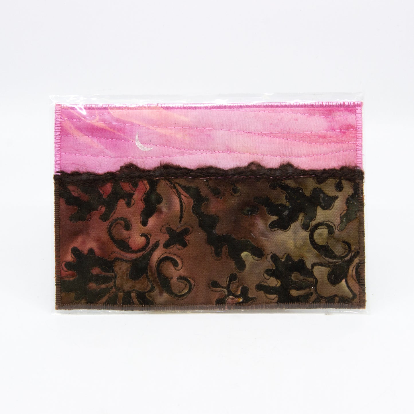 Mini art quilt of a prairie: Pink sky with moon, brown field with paisley pattern 