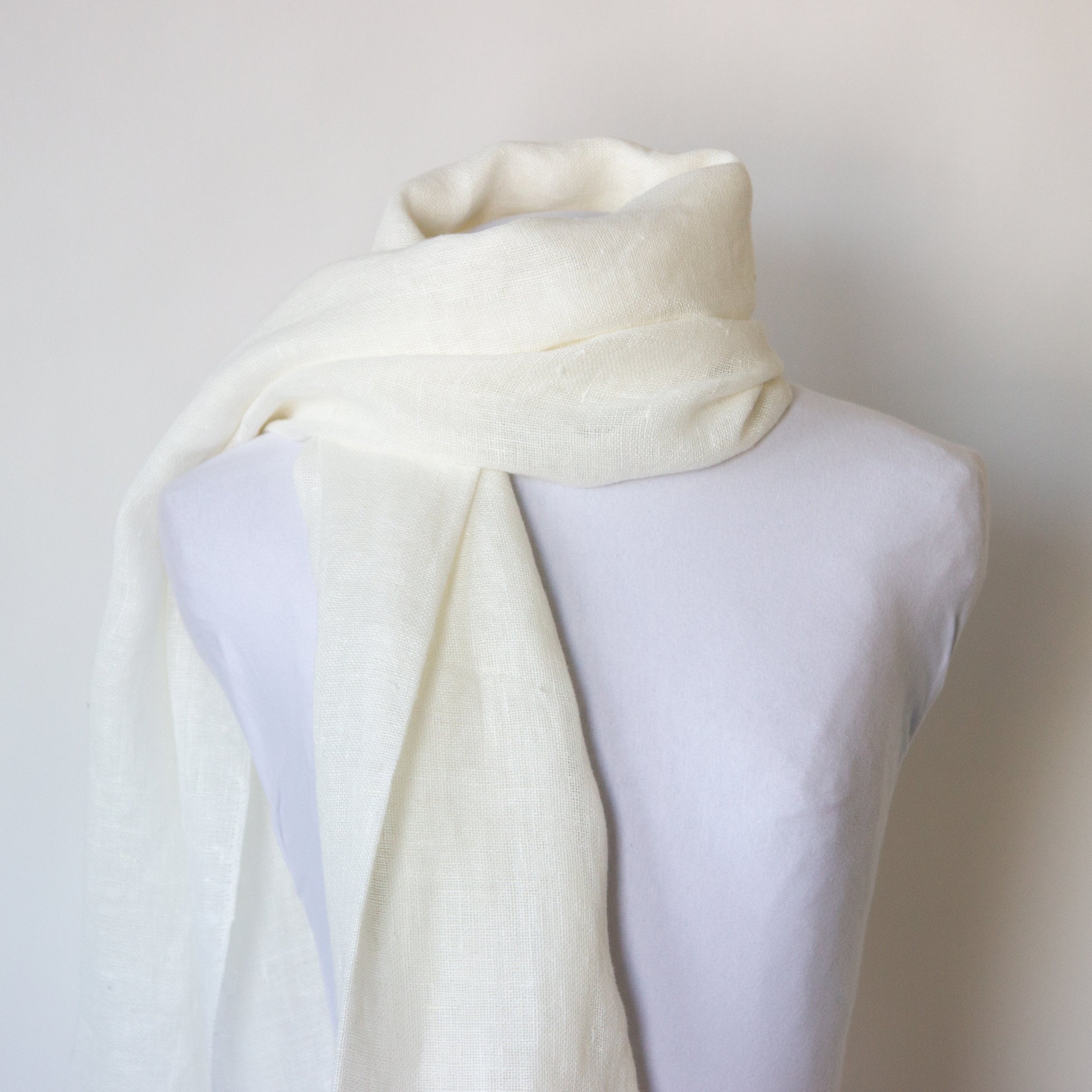 White linen scarf with tassels: over the shoulder 