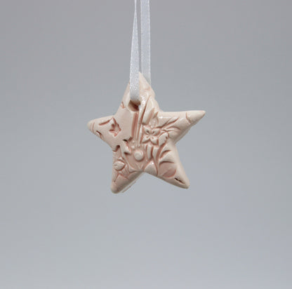 Light pink star ornament embossed with floral pattern