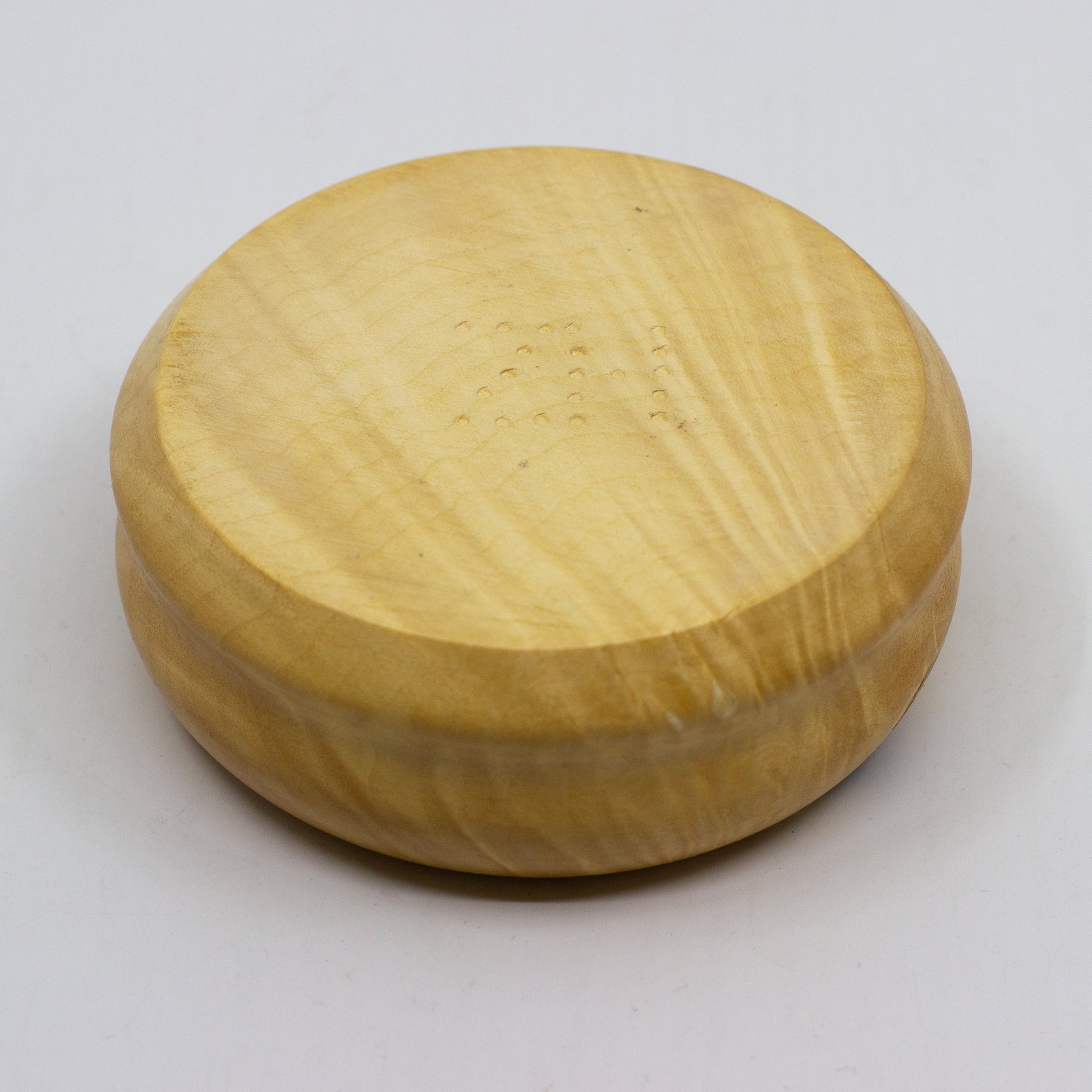 Bottom of light tan wooden bowl